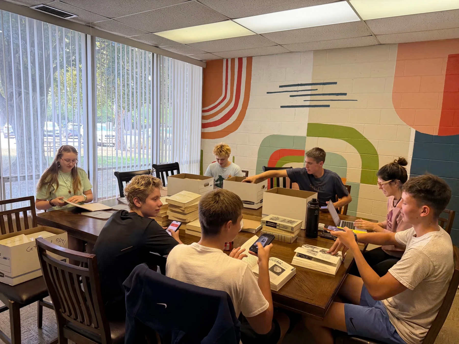 Student archivists sorting, identifying, and photographing materials together
